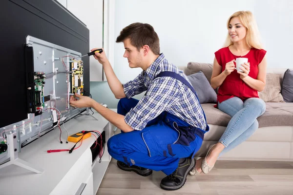 depositphotos_137860252-stock-photo-technician-repairing-television-at-home